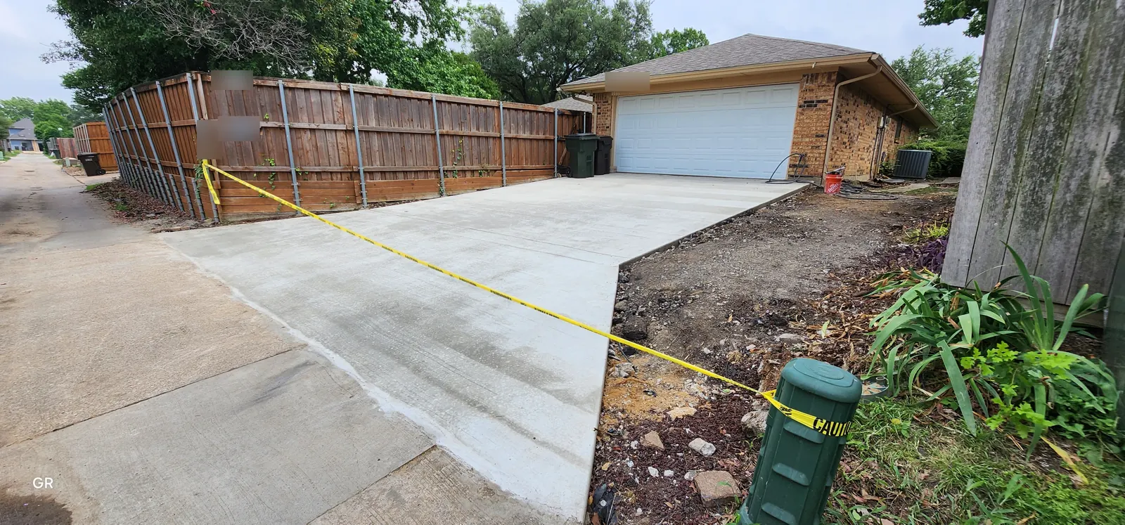 New driveway and alley approach taped off while it cures