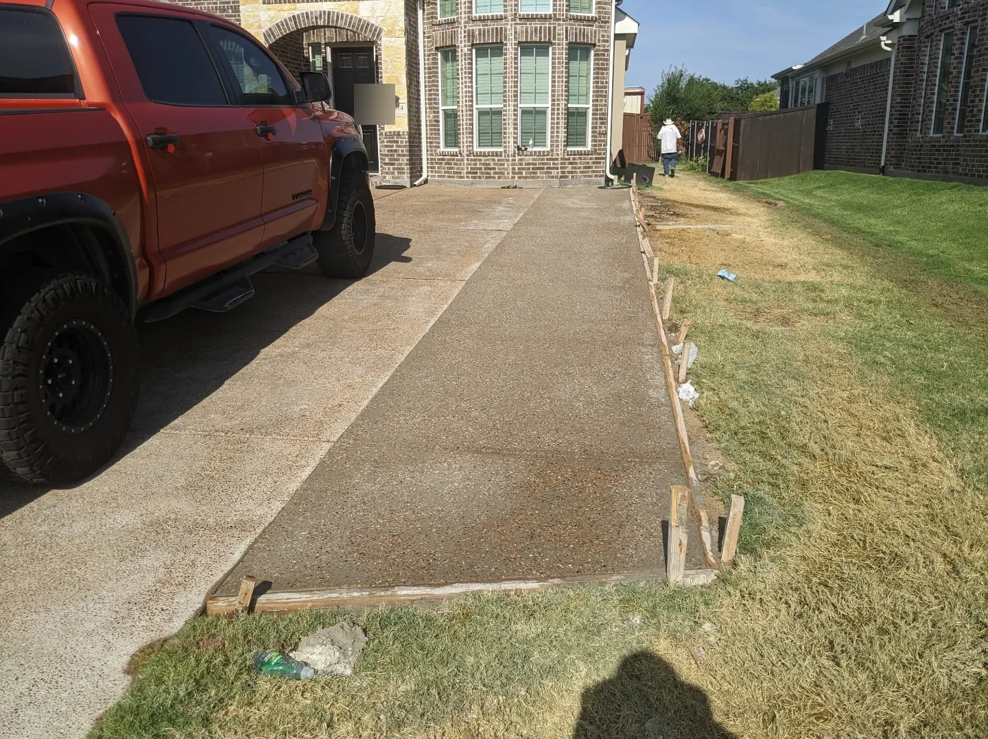 Exposed aggregate driveway extension beside an existing driveway, forms still in place