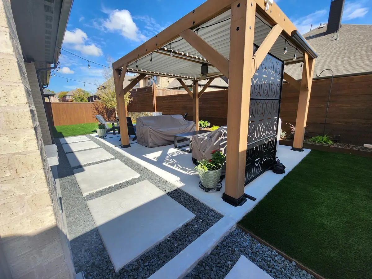 Backyard outdoor living space with a louvered pergola, paver stepping-stone path, gravel and artificial turf