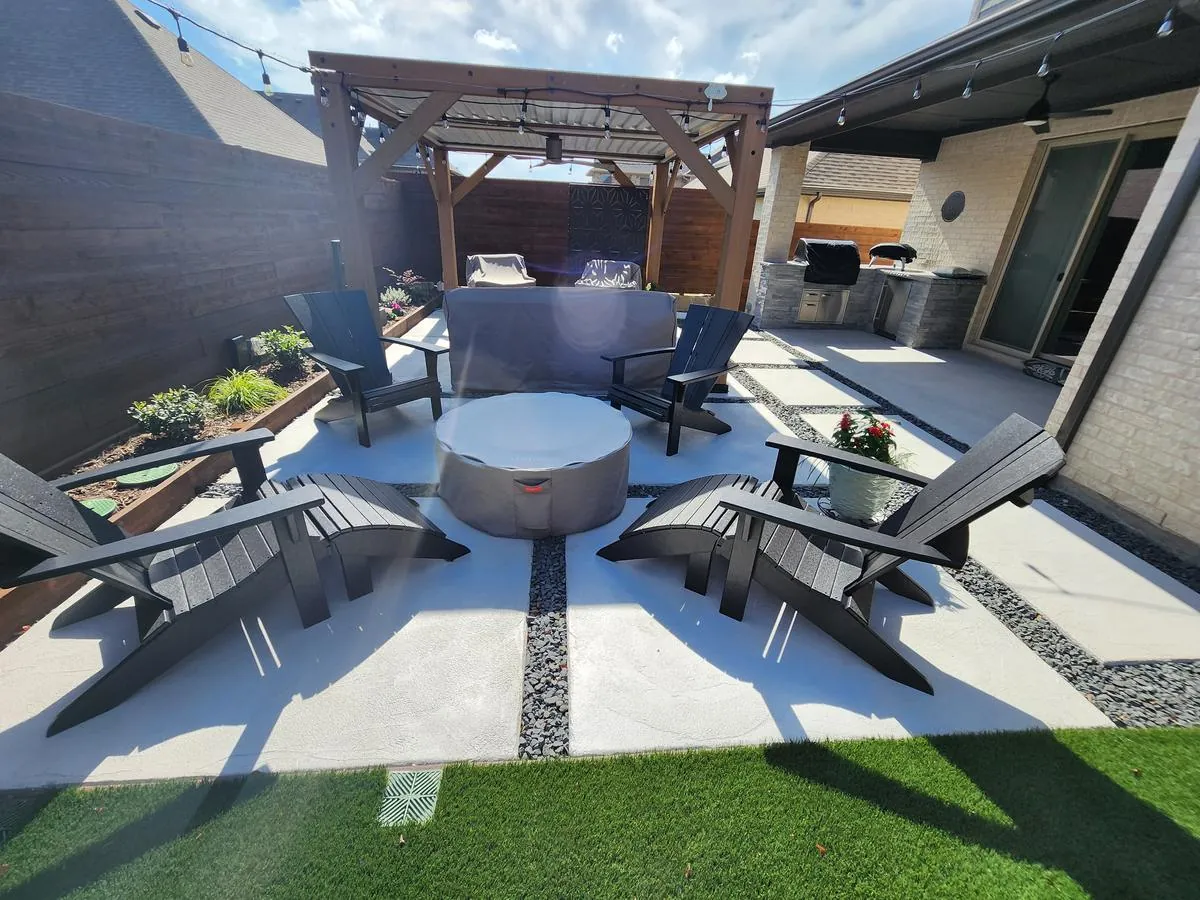 Backyard patio with pergola, Adirondack seating, a fire feature and outdoor kitchen