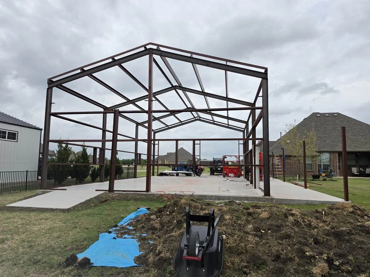 Red-oxide steel frame of a metal building under construction