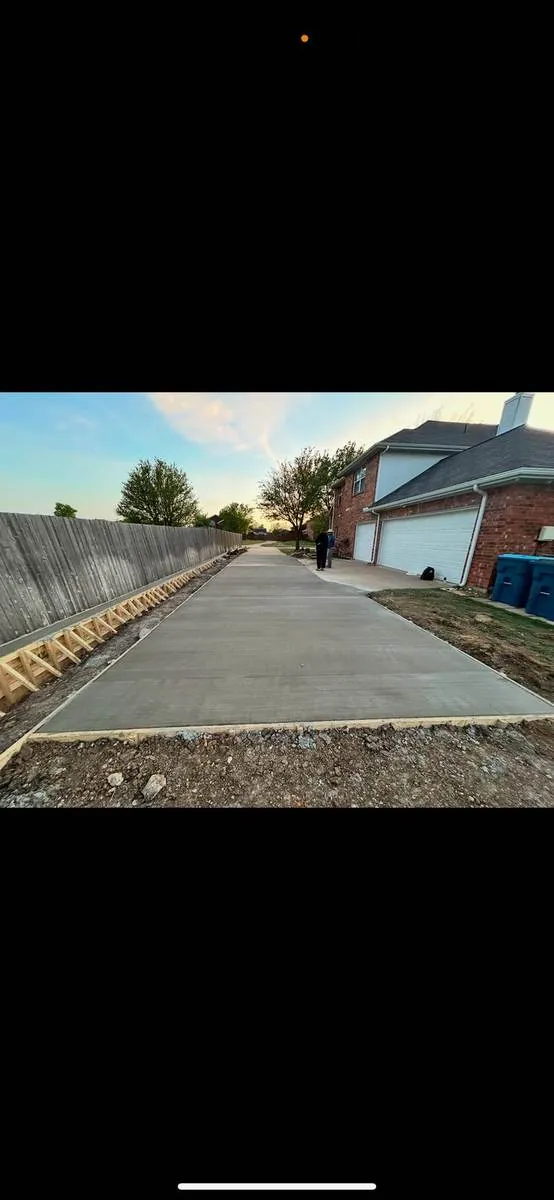 Long new concrete driveway at dusk