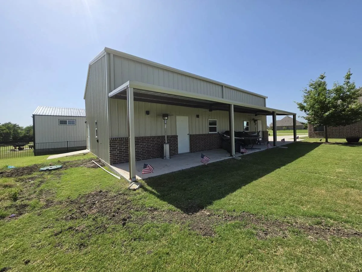 Metal building with a covered porch and brick wainscot