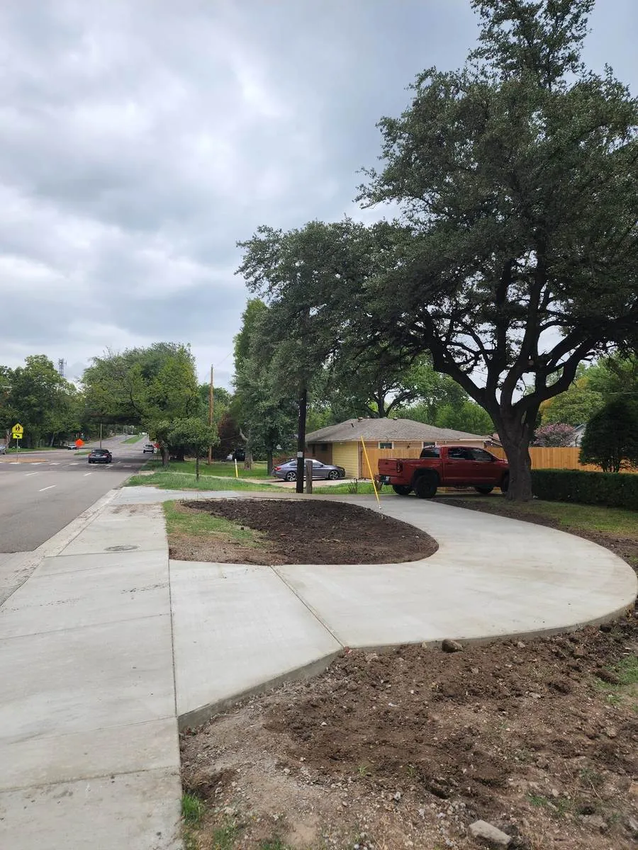 Curved concrete driveway and street approach with fresh finish