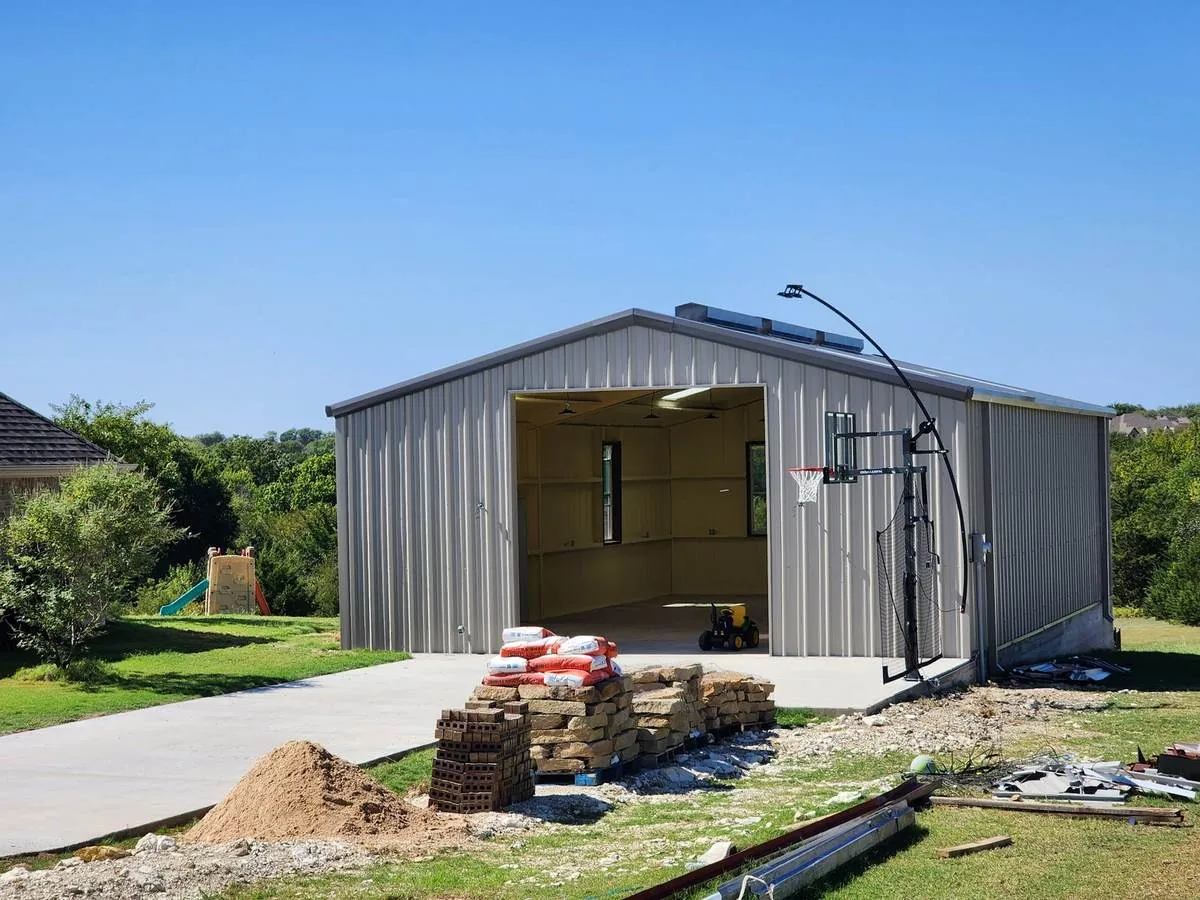 Gray metal workshop with an open bay door