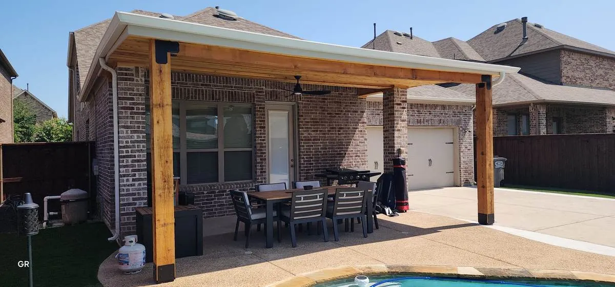 Covered patio addition on the back of a brick home