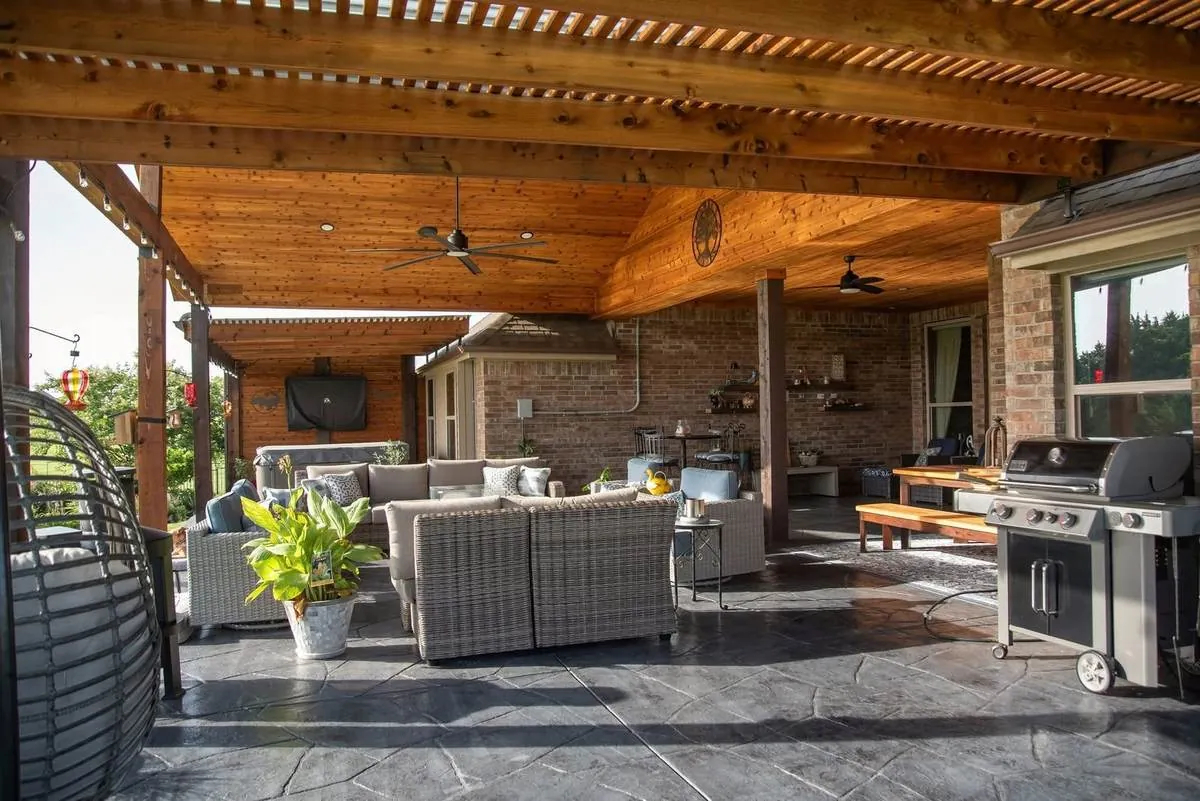 Fully furnished covered patio with cedar ceiling and stamped concrete floor
