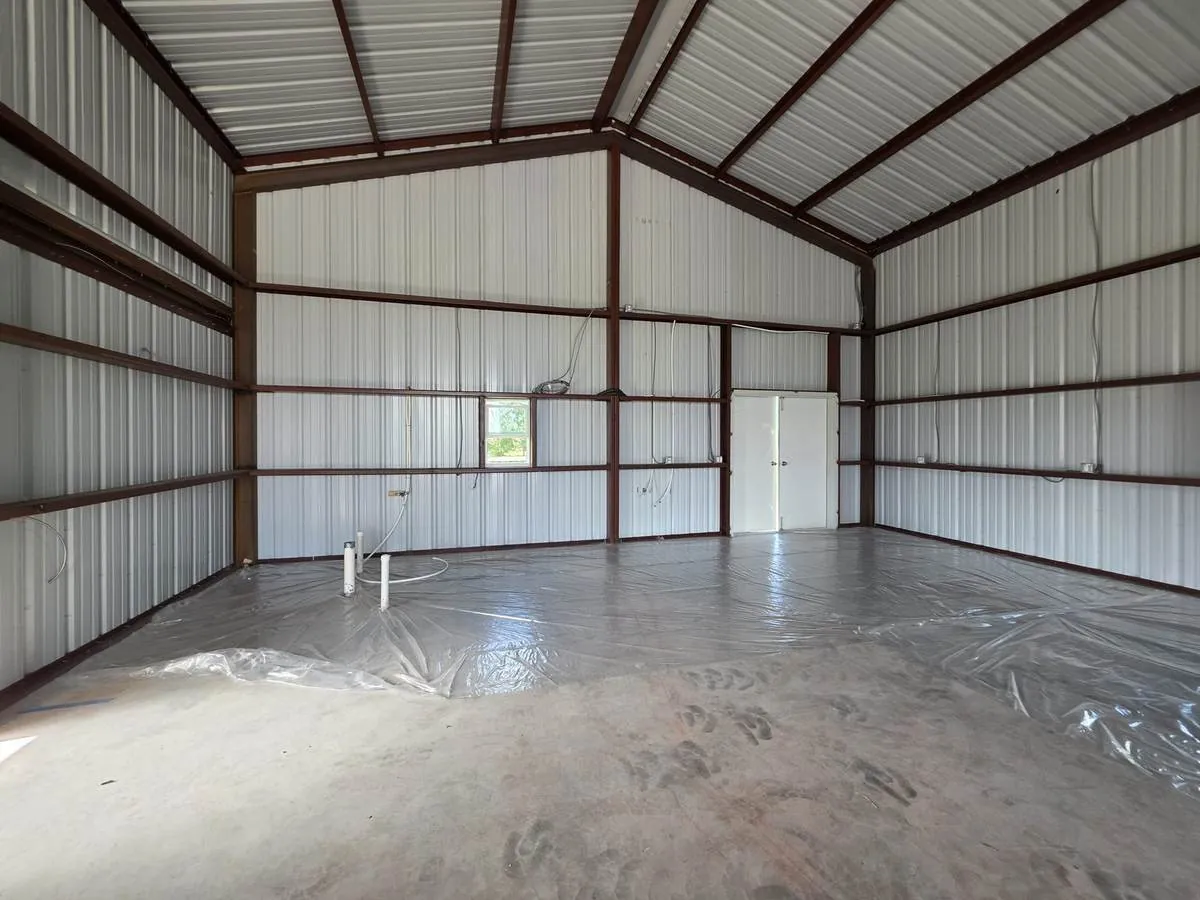 Interior of a finished metal building with white liner panels