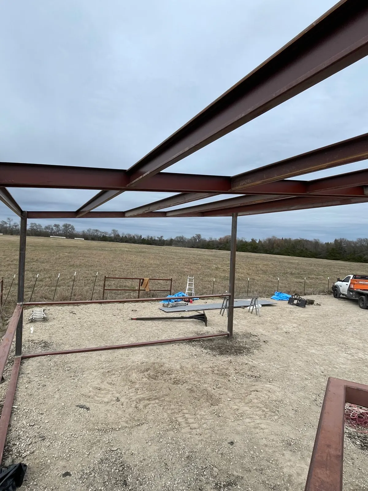 Looking up at the steel beams and purlins of a shop frame